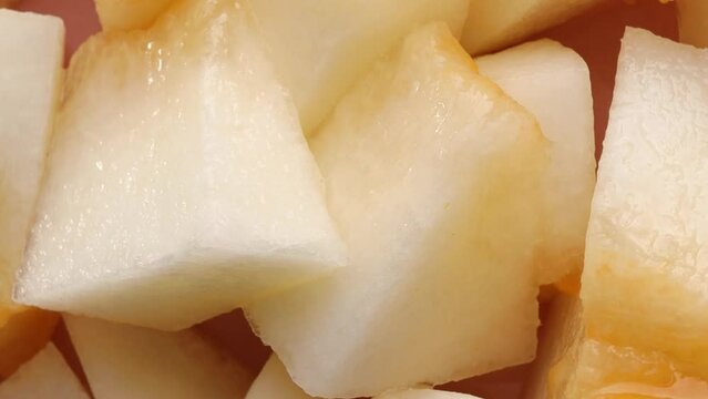 Fresh melon pieces, rotation in circle. slices of ripe juicy melon Turning. selective focus.  