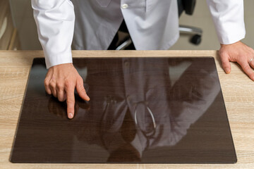 Mock-up template. Doctors check patient information and find disease points through display at table.