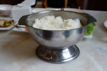A container that holds rice for many people to eat.