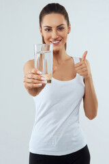 Portrait of beautiful woman on isolated studio background, hold water glass. Drink water. Diet concept