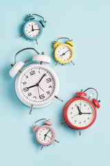 Collection of alarm clocks of different colors show different times. Start of the day, waking up,...