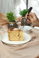 Salted Caramel Blondie cake slice include chocolate cream, sugar with fork, cup of coffee and pot served plate isolated on napkin side view of cafe food