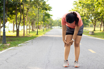 Injury and recovery in sports, Female holding her sore leg after accident. Runner woman massaging sore calf muscles during running training outdoor from pain. Athlete with joint or muscle soreness. - obrazy, fototapety, plakaty