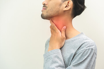 Sick, hurt asian young man sore throat pain, have a fever, flu check self touching massage neck....