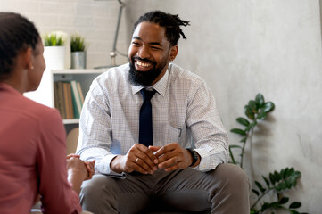 A psychotherapist session with a patient. African-American women and men have a meeting.  - obrazy, fototapety, plakaty