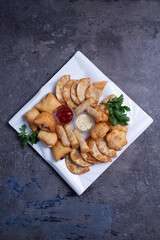 chebureks, samsa and baursaki assorted snacks of Asian cuisine top view