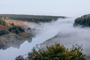 Autumn landscape.Forest and river with fog.