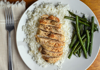 sliced chicken breast  on rice with green beans