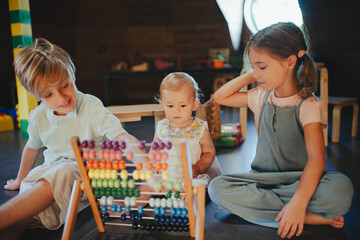 Children are playing together in indoor play area at a restaurant.