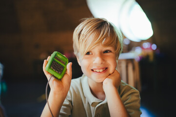 Portrait of boy playing as cashier in a store.
