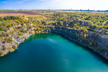 Flooded and abandoned granite quarry with clear turquoise water. Drone. Aerial view