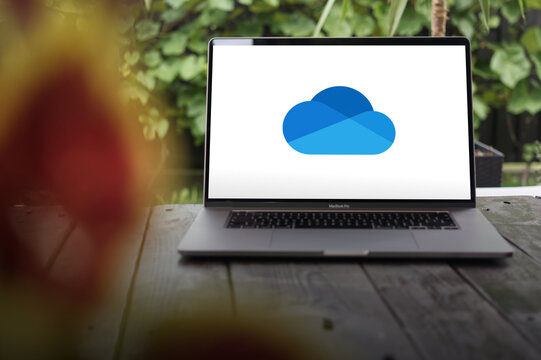 OneDrive logo, a file hosting service operated by Microsoft, displayed on a MacBook Pro screen