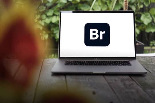 Adobe Bridge logo, free digital asset management app made by Adobe Inc., displayed on a MacBook Pro screen