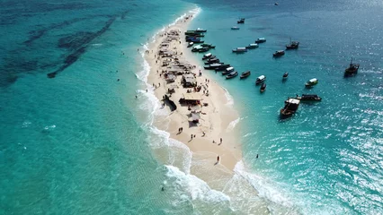 Fotobehang Aerial drone view of tiny and beautiful Nakupenda island on Zanzibar archipelago. Small sandy island is surrounded by many boats and incredible turquoise water of Indian ocean. Nakupenda, Zanzibar © Pavol