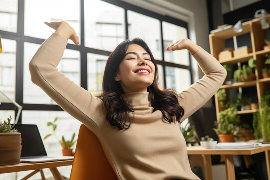 Graphic designer stretching her arms - Powered by Adobe