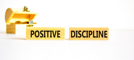 Positive discipline symbol. Concept words Positive discipline on beautiful wooden blocks. Beautiful white background. Wooden chest coins. Business psychology positive discipline concept. Copy space.