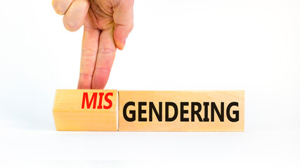 Gendering or misgendering symbol. Concept words Gendering Misgendering on wooden blocks. Beautiful white background. Psychologist hand. Gendering or misgendering concept. Copy space.