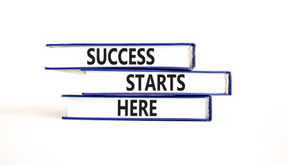 Success starts here symbol. Concept word Success starts here on beautiful books. Beautiful white table white background. Business motivational success starts here concept. Copy space.