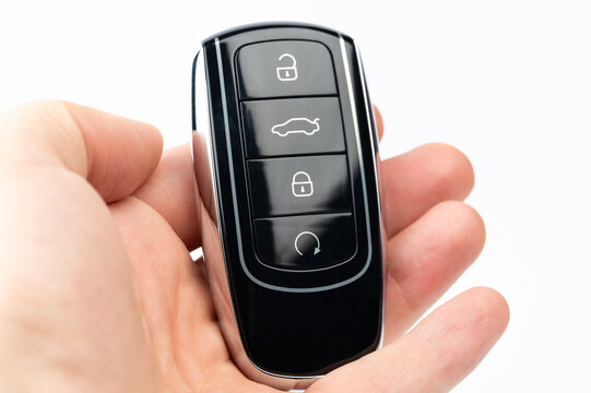 Modern black car key in palm hand