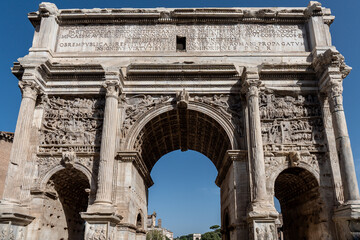 Fototapeta na wymiar Arch of Titus in the Via Sacra near the Roman Forum in Rome, Italy. Monument made of stone