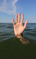 hand while drowning in the ocean and asking for help symbol of failure and failure