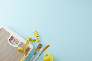 Weight shedding progress. Top view photo of weight scale, cutlery, tape measure, green apple on pastel blue background with advert area - obrazy, fototapety, plakaty