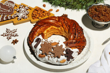 Plate with tasty Christmas pastry wreath, kutya, cookies and almond on light background