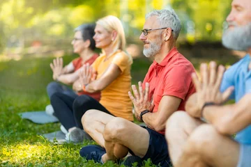 Fotobehang Group Of Mature People Meditating Together In Lotus Position Outdoors © Prostock-studio