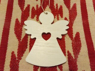 wooden angel on an embroidered towel