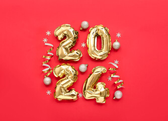 Composition with figure 2024 made of golden foil balloons and Christmas decorations on red background