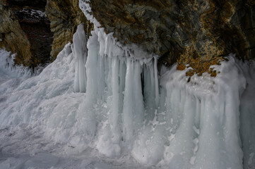 ice caves of Lake Baikal. Frozen icicles and splashes. Frozen lake Baikal in winter in Russia