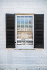 Fototapeta premium window with open shutters in a brick wall