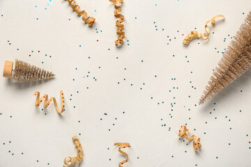 Frame made of Christmas fir trees and decor on light background