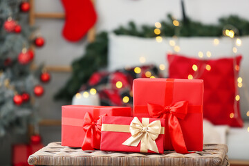 Gift boxes on table in living room with Christmas decor, closeup