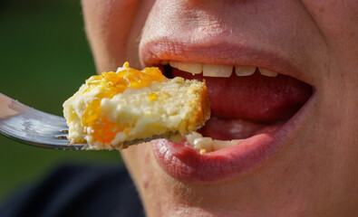 close up of a woman eating a piece of cake