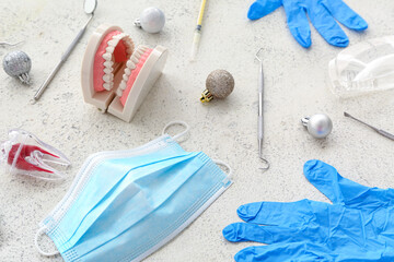 Dentist's tools with Christmas decor on grunge background