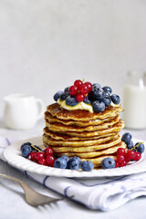 Banana pancakes with fresh berries for a breakfast.