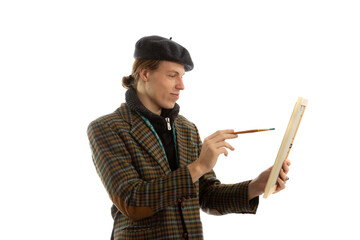 Young smiling artist with a beret on his head on a white background