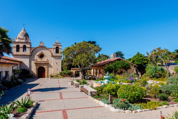 carmel mission basilica with garden and church