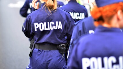 Police sign - logo on the back of the police uniform. Policja. © Grand Warszawski