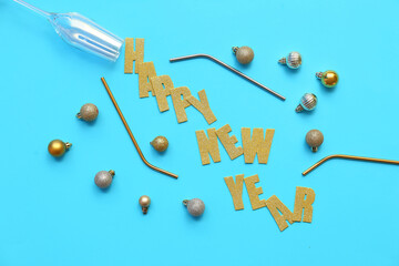 Text HAPPY NEW YEAR with Christmas balls and straws on blue background