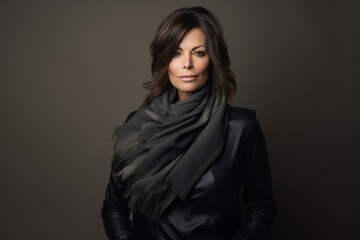 Portrait of a beautiful brunette woman in a black scarf.