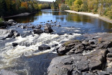 view upstream Red river near the Iroquois falls at Labelle , Quebec Canada Autumn landscape