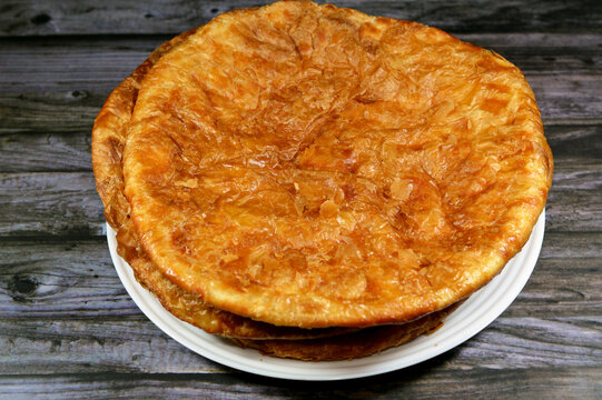 Egyptian Feteer meshaltet, layers upon layers of pastry dough with loads of ghee or butter in between, one of the famous Egyptian pastry recipes, a flaky Egyptian layered pastry bread dough and butter