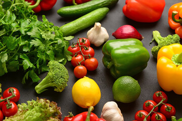 Different fresh vegetables and parsley on black background