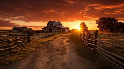 Deurstickers A farm scene with the sun setting behind the barn © Michael