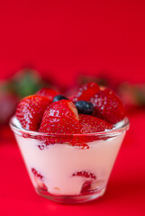 Strawberries with Yogurt, whipped cream on a Red Background