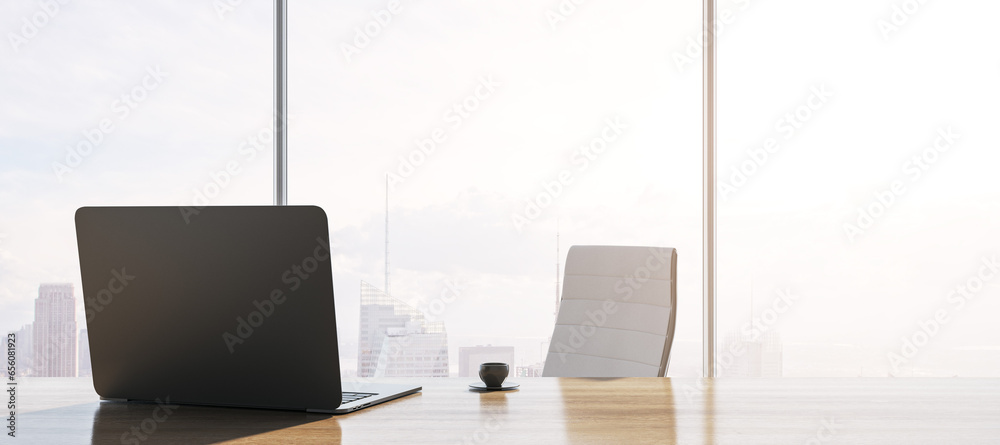 Poster close up of contemporary backlit wooden desk with laptop, table lamp, coffee cup and panoramic windo