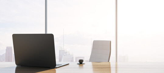 Fototapeta premium Close up of contemporary backlit wooden desk with laptop, table lamp, coffee cup and panoramic window with city view in the background. 3D Rendering.