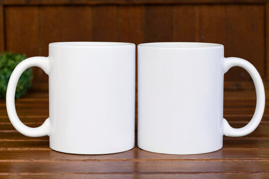 2 White 11 oz white mug on a green wooden background  . 11oz cups mock up for your front - back design